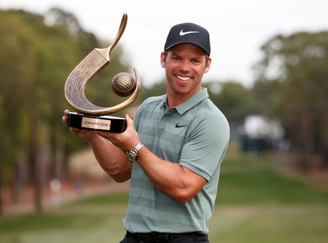 Paul Casey holds up the champion's trophy after winning the Valspar Championship golf tournament Sunday, March 11, 2018, in Palm Harbor, Fla. (AP Photo/Mike Carlson)