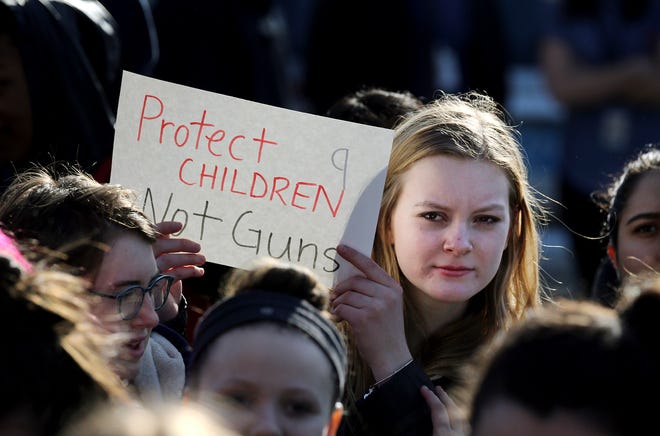 In this Feb. 28, 2018 photo, Somerville High School junior Megan Barnes marches with others during a student walkout at the school in Somerville, Mass. A large-scale, coordinated demonstration is planned for Wednesday, March 14, when organizers have called for a 17-minute school walkout nationwide to protest gun violence. (Craig F. Walker/The Boston Globe via AP)