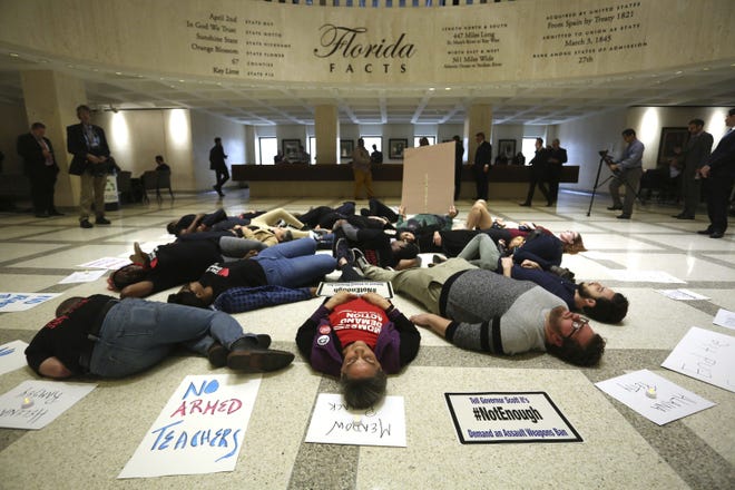 About 20 protesters participate in a die-In on the fourth floor rotunda of the Florida Capitol, in Tallahassee on March 6 as they continue to push for an assault weapons ban. [Scott Keeler/The Tampa Bay Times via AP]