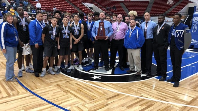 The Wellington boys basketball team and their runner-up trophy from the State Tournament in Lakeland on Saturday. Jodie Wagner/Palm Beach Post.