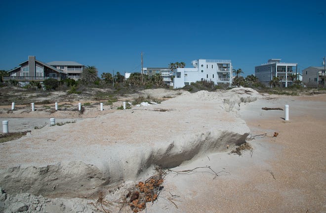 A barrier of sand sits at the end of Porpoise Point Drive in Vilano Beach on Thursday. To help prevent flooding in community from recent heavy surf, St. Johns County dumped multiple truckloads of sand at the end of the road. [PETER WILLOTT/THE RECORD]
