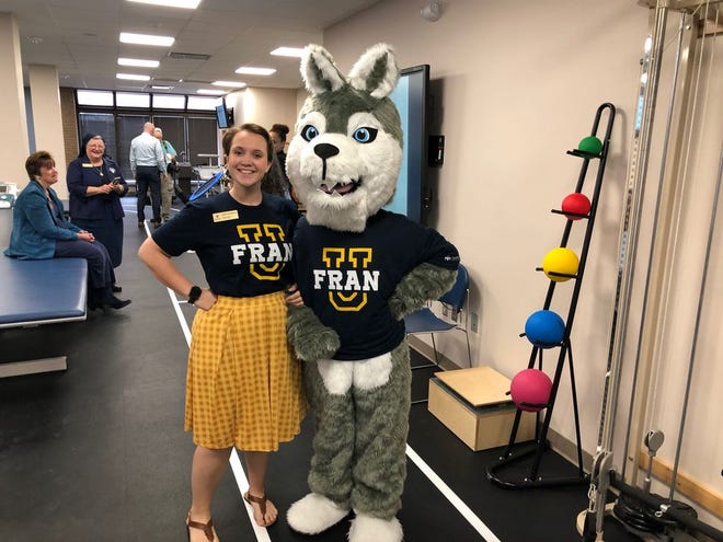 FranU's mascot poses with a student in the renovated Physical Therapy lab-classroom.