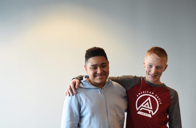 Ravenna seventh-grader Eathan Cobbin, 14, left, was honored recently for saving the life of his friend, Christian Neff, after Christian choked on food during lunch.