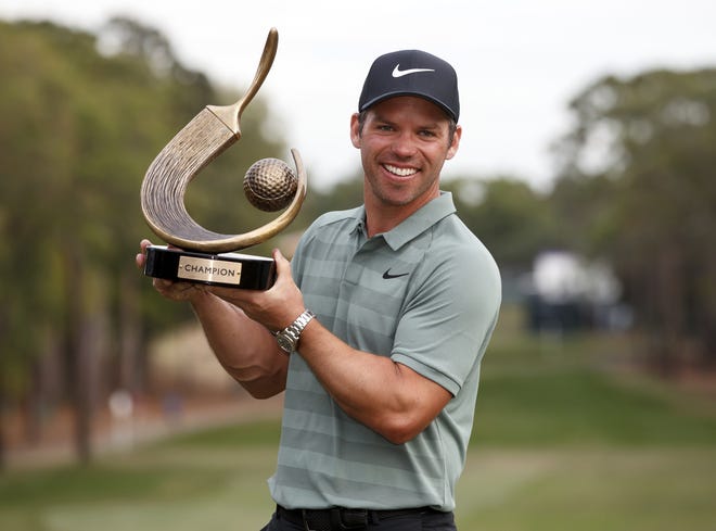 Paul Casey holds up the champion's trophy after winning the Valspar Championship on Sunday in Palm Harbor. [Mike Carlson/The Associated Press]
