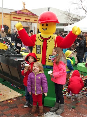 Children pose for a photo with Bertie the Builder, the Legoland Discovery Center mascot, at the Feb. 6 groundbreaking.