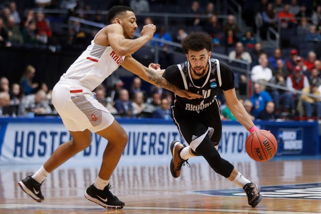 LIU Brooklyn's Julian Batts, right, drives against Radford's Carlik Jones during the first half of a First Four game of the NCAA men's college basketball tournament, Tuesday, March 13, 2018, in Dayton, Ohio. (AP Photo/John Minchillo)