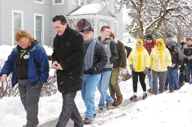 A remembrance walk was held Tuesday to honor the four victims who died five years ago on March 13, 2013 in Mohawk and Herkimer during a mass shooting. Pictured walking in front along West Main Street during the event are Linda Springer, of Mohawk, on left, and county Legislator Robert Schrader. [STEPHANIE SORRELL-WHITE/TIMES TELEGRAM]