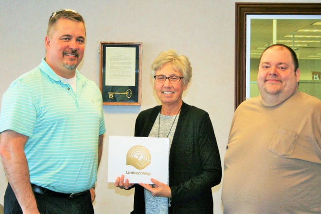 Eaton Corporation’s Lincoln Plant Manager, Erik Olson, right, along with Brian Sanders, left, President of the IAM Local 1165 which represents a large number of Eaton employees, accept the Gold Award from the United Way of Logan County’s administrative director, Patti Becker. [Photo submitted]