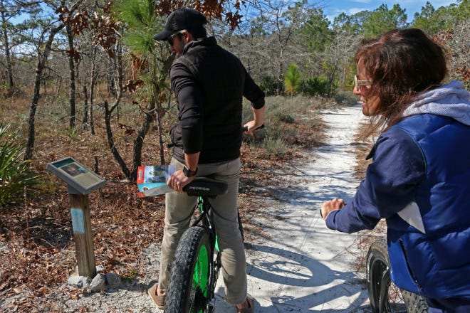 Jason Medina of Pedego 30A and Alison McDowell, executive director of the Choctawhatchee Basin Alliance, take a ride in Grayton Beach State Park using a new trail map they teamed up to create. [CBA/CONTRIBUTED PHOTO]