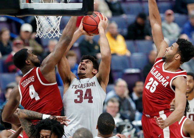 Texas A&M's Tyler Davis, trying to score on Alabama's Daniel Giddens during a Southeastern Conference tournament game last week, is one of the players PC will try to contain.