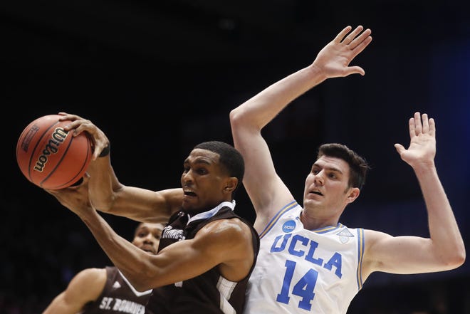 St. Bonaventure's Idris Taqqee, left, rebounds against UCLA's Gyorgy Goloman (14) during the first half of a First Four game of the NCAA tournament, Tuesday, in Dayton, Ohio. [The Associated Press]