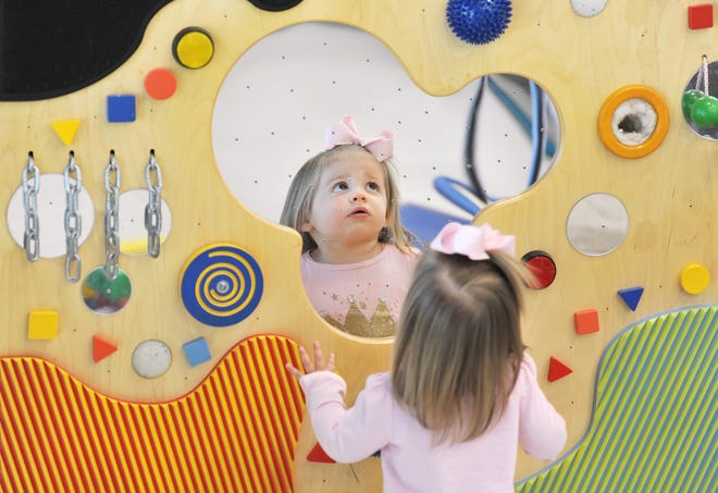 Rosemary Boyarovsky, who is 22 months old and has autism spectrum disorder, explores a sensory wall during an occupational therapy session at Wolfson Children's Hospital Rehabilitation Autism and Neurodevelopment Center. [BOB SELF/FLORIDA TIMES-UNION]
