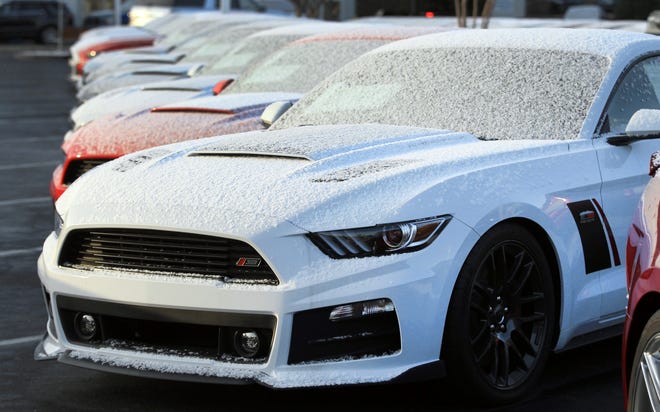 New cars at Tindol Ford Subaru in Gastonia are dusted with snow after a snow squall passed through the area Wednesday morning. [JOHN CLARK/THE GASTON GAZETTE]