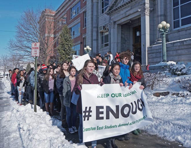 Cranston High School East students walk out of school Wednesday morning in response to a call for student demonstrations nationwide on the one-month anniversary of the Parkland, Florida, shootings. [The Providence Journal / Sandor Bodo]