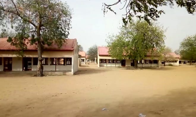 This image taken from video shows the exterior of Government Girls Science and Tech College in Dapchi, Yobe State, Nigeria on Thursday Feb. 22, 2018. As a painful debate about school safety rages in the U.S., President Donald Trumpâ€™s proposal to put more guns in schools carries echoes of the questions being asked in the northeast Nigeria. Determined to do something, the government has deployed armed guards to schools as parents debate the merits of giving guns to teachers themselves. (AP Photo)