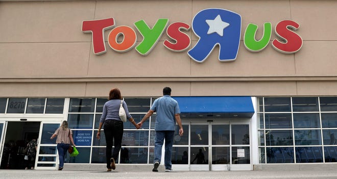 FILE - In this Tuesday, Sept. 19, 2017, photo, shoppers walk into a Toys R Us store, in San Antonio. Toys R Us's management has told its employees that it will sell or close all of its U.S. stores. The 70-year-old retailer is headed toward shuttering its U.S. operations, jeopardizing the jobs of some 30,000 employees while spelling the end for a chain known to generations for its sprawling stores and Geoffrey the giraffe mascot. The closing of the company's 740 U.S. stores will finalize the downfall of the chain and force toy makers and landlords to scramble for alternatives. (AP Photo/Eric Gay, File)