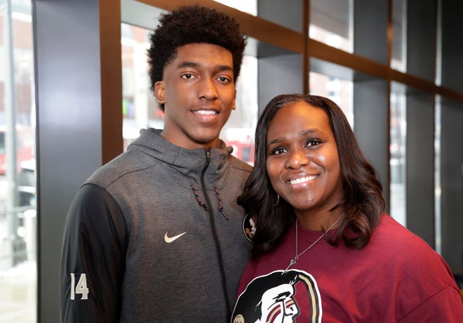 In this Wednesday, March 7, 2018 photo, Rhode Island women's basketball coach Daynia La-Force, right, poses for a photograph with her son Florida State's Terance Mann, left, at the Atlantic Coast Conference tournament, in New York. Mann is one of the few Division I players who learned most of the game from his mom. (AP Photo/Frank Franklin II)