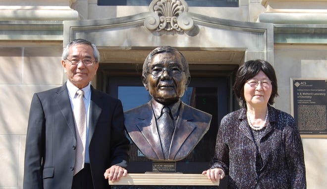In this April 18, 2014, file photo, Nobel laureate and Purdue University professor Ei-ichi Negishi, left, stands with his wife Sumire after the unveiling of a bronze sculpture of him outside of Wetherill Laboratory of Chemistry on campus at Purdue University in West Lafayette, Ind. Sumire Negishi was found dead Tuesday, March 13, 2018, in a northern Illinois landfill after her 82-year-old husband was found wandering a road south of Rockford, Ill., police said. (Steve Scherer/Purdue University via AP)