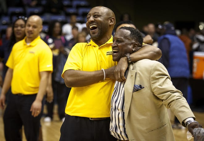 Springfield Southeast assistant coach Chuck Shanklin celebrates with Donny Brandon, a member of the 1980 Southeast team, after the Spartans' victory in a Class 3A supersectional. GATEHOUSE MEDIA ILLINOIS