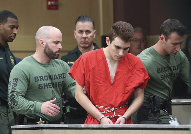 Nikolas Cruz is lead into the courtroom before being arraigned at the Broward County Courthouse in Fort Lauderdale, Fla., on Wednesday, March 14, 2018. Cruz is accused of opening fire at Marjory Stoneman Douglas High School in Parkland, Fla., Feb. 14, killing 17 students and adults. (Amy Beth Bennett/South Florida Sun-Sentinel via AP, Pool)