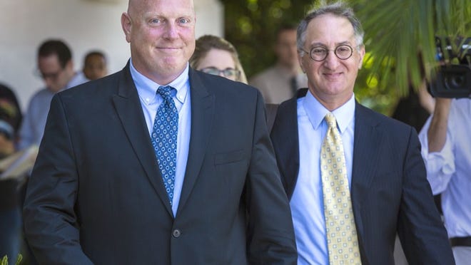 West Palm Beach attorney Bruce Reinhart, right, with his client, former Boynton Beach police officer Michael Brown, outside the federal courthouse last month. (Lannis Waters / The Palm Beach Post)