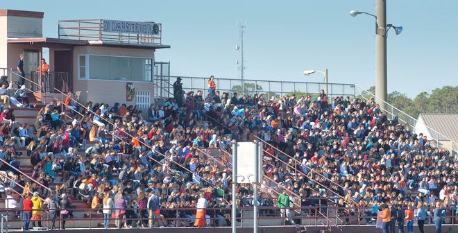 St. Augustine High School students fill the school's football stadium during the National School Walkout to demand stricter gun law and stop school shootings on Wednesday. The students gathered with teachers at 10 a.m. in the stadium and stayed out of class for 17 minutes while the names of the 17 people killed in Marjory Stoneman Douglas High School in Parkland last month were read aloud. [PETER WILLOTT/THE RECORD]