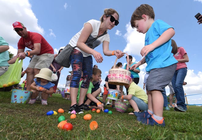 Kids hunt for eggs at the Battleship Easter Egg Hunt Carnival at Battleship Park in April 2017. [STARNEWS FILE PHOTO]