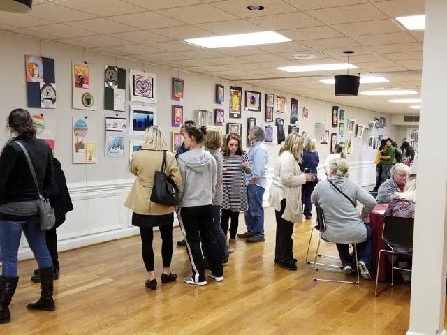 Students, parents and other members of the community examine exhibits during the Arts Davidson County Student Art Exhibit at the Edward C. Smith Civic Center on March 8. [Kim Kanoy/Kanoy Creative]