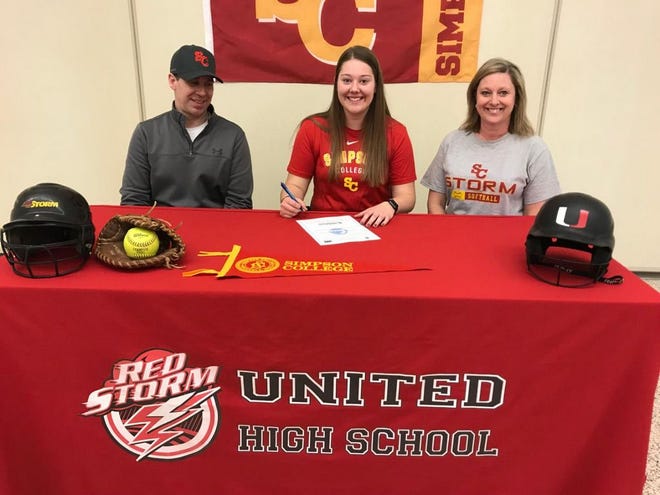 United senior Claire Oetting is pictured with her parents after officially signing to play softball with Simpson College.  JEFF HOLT/REVIEW ATLAS