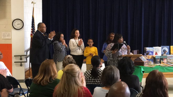 The Sadler family is recognized by Paradigm 360's Christina Lee for their contributions to education and the community during a ceremony at the Edward D. Sadler Jr. Elementary School in Gastonia on Friday, March 16, 2018. From left, retired Superintendent Edward Sadler, his daughter-in-law Celeste Sadler, and his grandchildren Maya and Witt. [ERIC WILDSTEIN/THE GASTON GAZETTE]