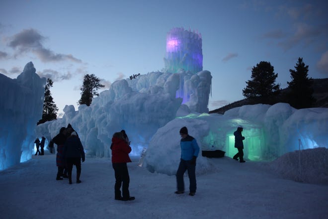 Visitors to the Ice Castle enjoy its mazes, slides and ice sculptures at dusk in Dillon, Colorado. [Steve Stephens]