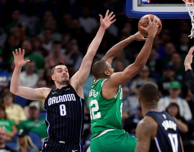 Boston's Al Horford drives to the basket past Orlando's Mario Hezonja during Friday's game.