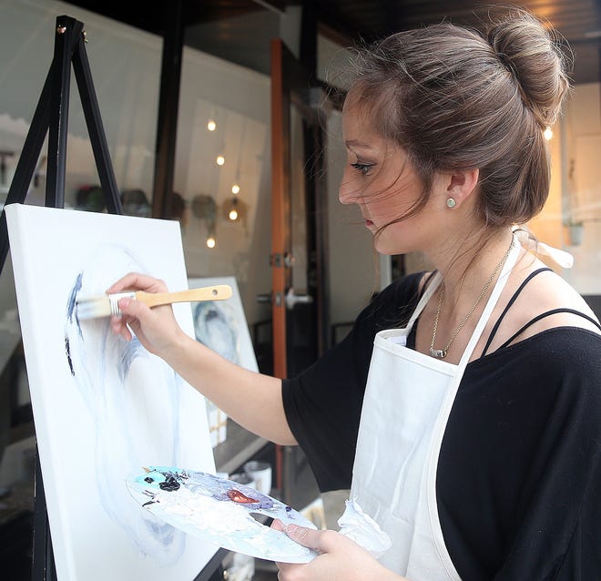 Amber Leblanc works on a painting Friday in downtown Thibodaux during Art Walk. The event gives local artists a chance to show their work. [Abby Tabor/Staff -- dailycomet/houmatoday]