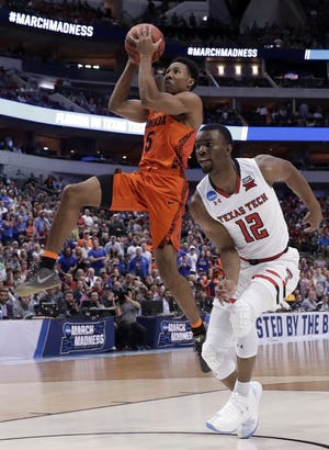 Florida guard KeVaughn Allen (5) goes to the basket in front of Texas Tech guard Keenan Evans (12) during the first half of a second-round game at the NCAA men's college basketball tournament in Dallas, Saturday. [The Associated Press / Tony Gutierrez]