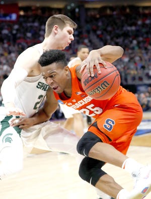 Syracuse guard Tyus Battle (right) drives on Michigan State guard Matt McQuaid during the second half of Sunday’s second-round NCAA tournament game in Detroit.       

[Paul Sancya / Associated Press]