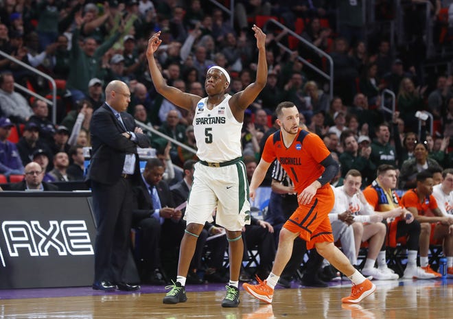 Michigan State guard Cassius Winston (5) reacts to hitting a basket against Bucknell during the first half of an NCAA men's college basketball tournament first-round game in Detroit on Friday. [AP Photo/Paul Sancya]