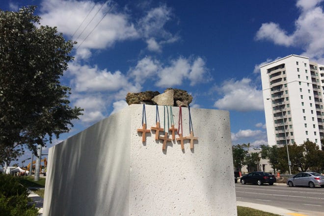 Six crosses are placed at a makeshift memorial on the Florida International University campus in Miami on Saturday, March 17, 2018, near the scene of a pedestrian bridge collapse that killed at least six people on March 15. (AP Photo/Jennifer Kay)