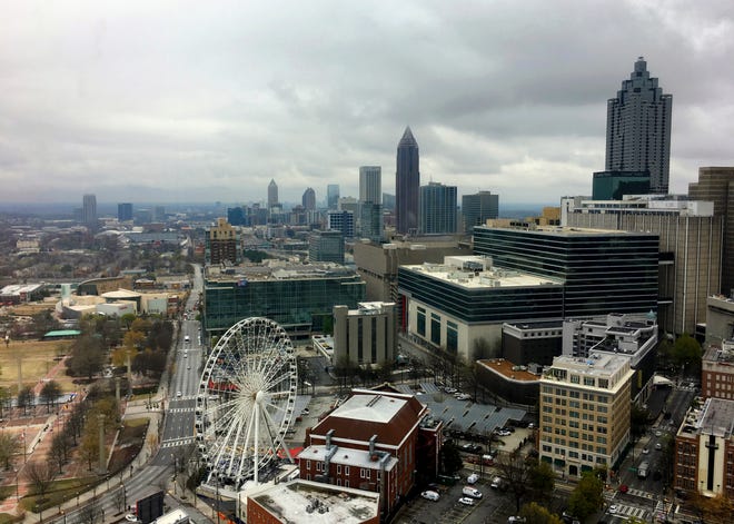 Clouds and wind move through the Atlanta area, Monday, March 19, 2018. More than 29 million people, including millions in Atlanta, face a threat of severe storms that could bring large, damaging winds and strong tornadoes to the southeastern United States, forecasters said. (AP Photo/Alex Sanz)