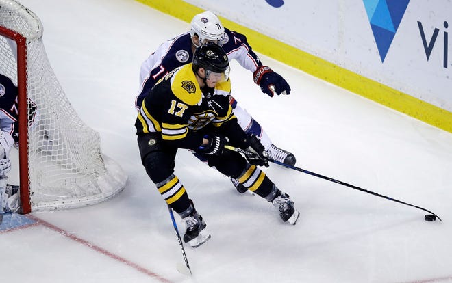 Bruins forward Ryan Donato, in his first NHL star, is chased by Blue Jackets winger Nick Foligno during the first period of Monday night's game in Boston.