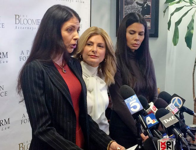 Former model Faviola Dadis, left, reads from a statement at a news conference with her attorney, Lisa Bloom, center, in Los Angeles Monday, March 19, 2018. Dadis, an aspiring actress says she was 17 when actor Steven Seagal sexually assaulted her during a supposed casting session in 2002. (AP Photo/Andrew Dalton)