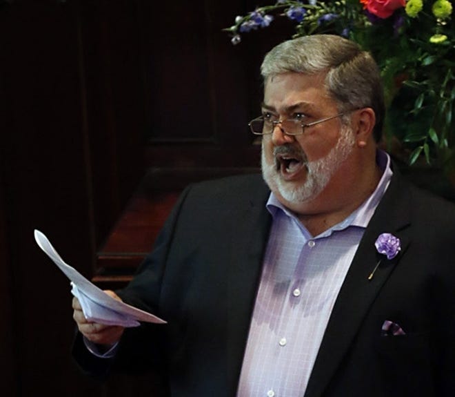 Reverend David Meredith (L) sings with the choir while standing next to his spouse Jim Schlachter during their wedding ceremony at the Broad Street United Methodist Church in Columbus, Ohio on May 7, 2016. The Church, where Meredith is a Pastor, was supportive of their union despite the negative opinion of gay marriage by the Methodist Church which states in it's "Book of Discipline Statements"- "41.6: Ceremonies that celebrate homosexual unions shall not be conducted by our ministers and shall not be conducted in our churches." (Columbus Dispatch photo by Brooke LaValley)