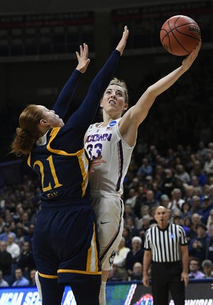Connecticut's Katie Lou Samuelson (33) shoots over Quinnipiac's Jen Fay during Monday's NCAA Tournament game in Storrs, Conn. [Jessica Hill/AP]