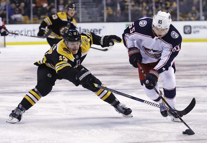 Bruins forward Ryan Donato, left, trying to poke the puck away from Blue Jackets defenseman Markus Nutivaara during Monday night's game, will play his second NHL game on Wednesday at St. Louis. [Charles Krupa/AP]