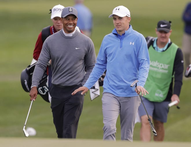 Tiger Woods, left, talks with Jordan Spieth as they approach the 17th green during the first round of the Valspar Championship earlier this month in Palm Harbor, Fla. Spieth is still winless so far in 2018. [AP Photo/Mike Carlson]