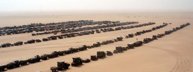 An assault convoy of trucks and amored vehicles of the101st Airborne Division's 3rd Brigade Combat Team prepare to cross into Iraq Friday, March 21, 2003. (AP Photo/Robert Woodward, US Army)