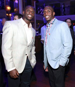 Twins Jason McCourty, left, and Devin McCourty, at an NFLPA function a few years ago, will both suit up for the same team this season for the first time since college.