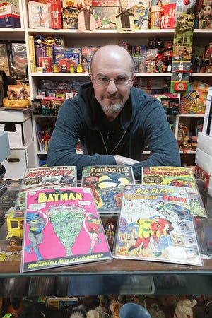 Jami Meeker, manager of The Toys Time Forgot in Canal Fulton, shows some of the 1,067 comic books in the Jimmy Scott collection, which will go on sale starting March 24. One of the books features the first appearance of notable super hero the Black Panther. The collection dates from 1963-1966, when Scott was killed in a motorcycle crash in his early 20s. (GateHouse Ohio Media / Kevin Whitlock, The Massillon Independent)