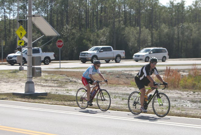 Cyclists ride along Bay Parkway, which Bay County plans to extend from its current end at Pier Park down to Nautilus Street. [PATTI BLAKE/NEWS HERALD FILE PHOTO]