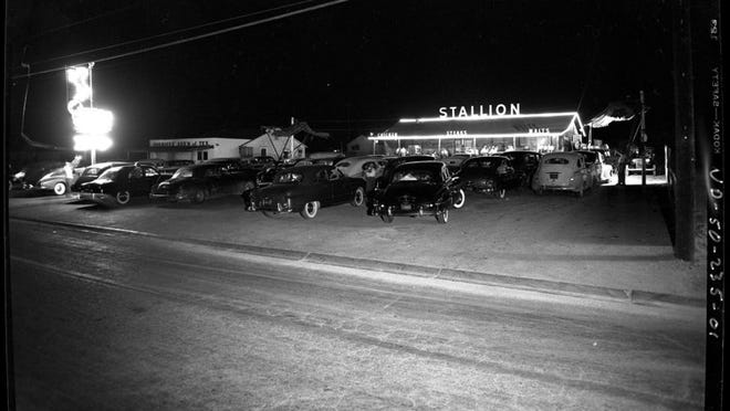 Night view of Stallion Drive Inn Restaurant and parking lot as photographed by Neal Douglass in 1950. Contributed by Austin History Center ND-50-235-01