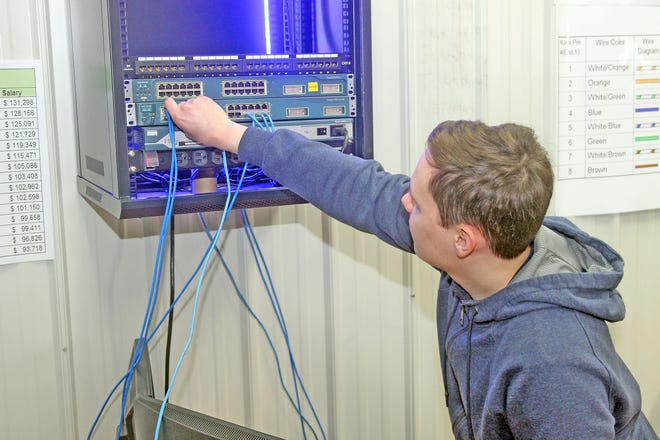 Vitaliy Konyukhov works on a network switch Tuesday morning at the Hillsdale Area Career Center. [COREY MURRAY PHOTO]